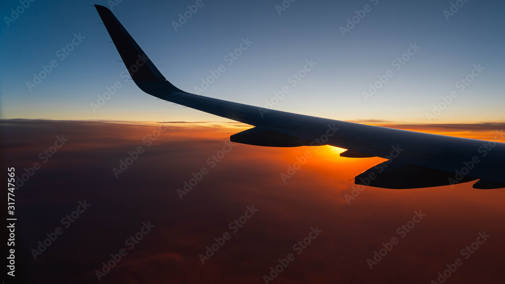 airplane wing on sunset background airplane wing on sunset background