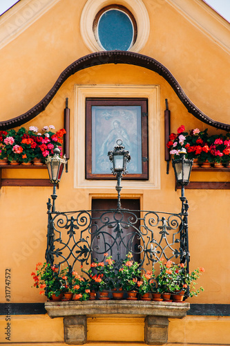 Religious Window with flower boxes in Prague