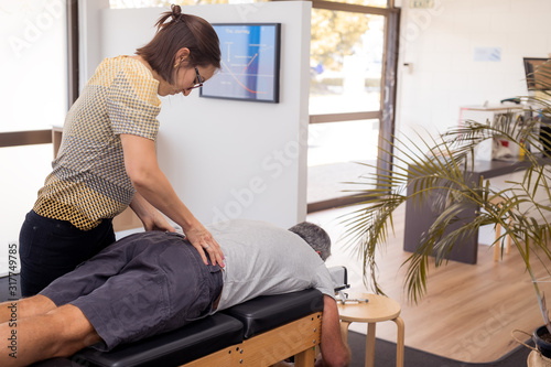 Fotografia Man having chiropractic back adjustment