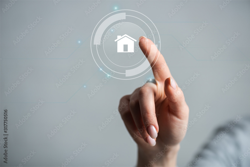 Cropped view of woman pointing with finger on house isolated on grey Cropped view of woman pointing with finger on house isolated on grey