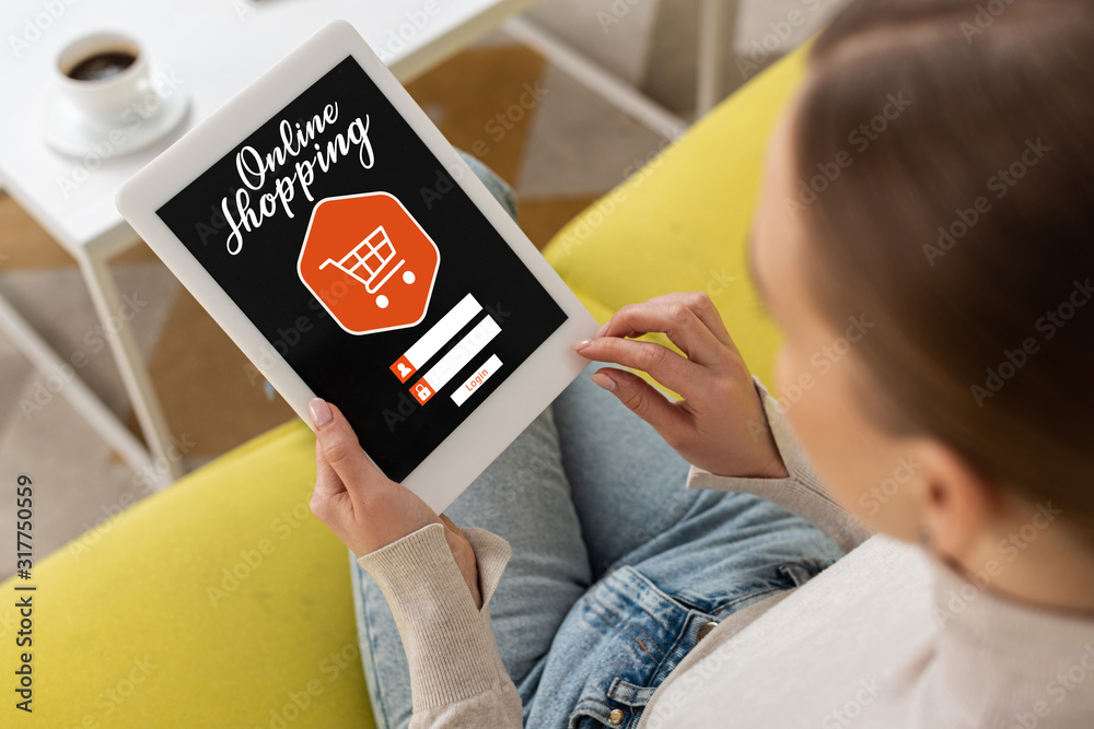 Overhead view of woman using digital tablet with online shopping lettering Overhead view of woman using digital tablet with online shopping lettering
