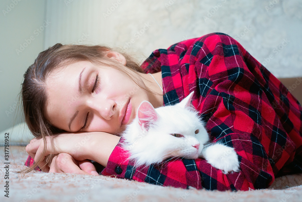 sleeping young girl with a white cat on the sofa. love for Pets, Pets sleeping young girl with a white cat on the sofa. love for Pets, Pets