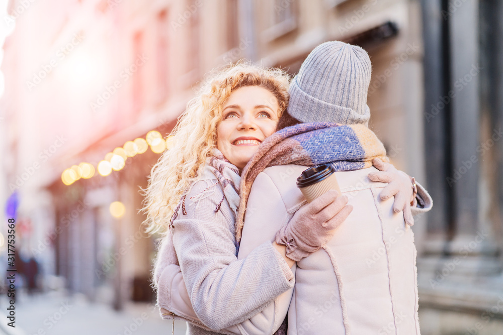 Happy brightful positive moments of two stylish girls hugging on street in city. Closeup portrait funny joyful attarctive young women having fun, smiling, lovely moments, best friends Happy brightful positive moments of two stylish girls hugging on street in city. Closeup portrait funny joyful attarctive young women having fun, smiling, lovely moments, best friends