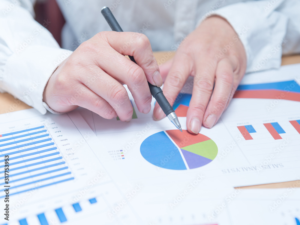 woman hand with pen and business report. Accounting woman hand with pen and business report. Accounting