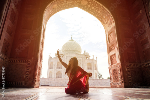 Indian woman in red saree/sari in the Taj Mahal, Agra, India