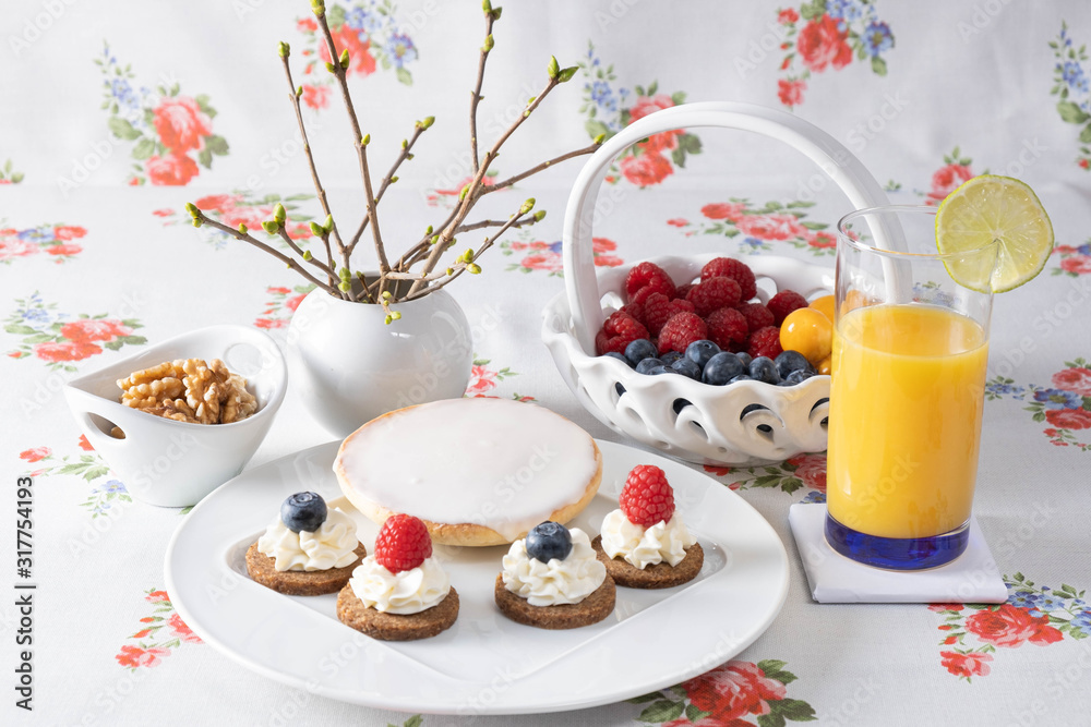 Orange juice with different berries and cakes. Orange juice with different berries and cakes.