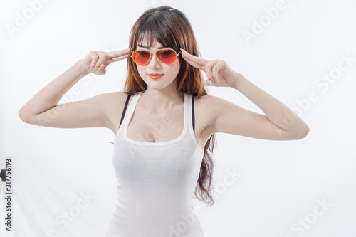Beautiful woman wearing a white tank top with red glasses.