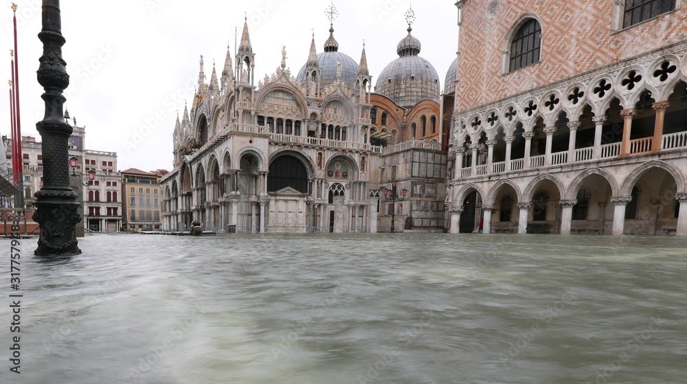 Basilica of Saint Mark in Venice with the square with water duri