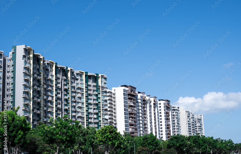 residential condominiums near a lake or river with green park ad trees