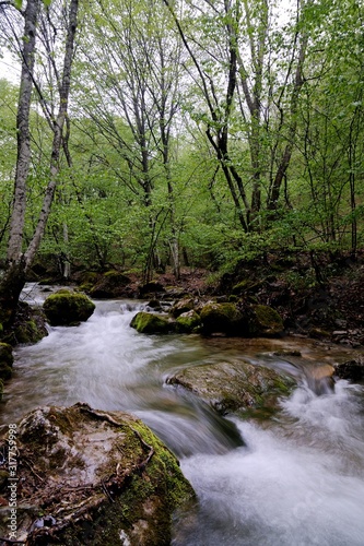 Stream with waterfall and mossy stones around