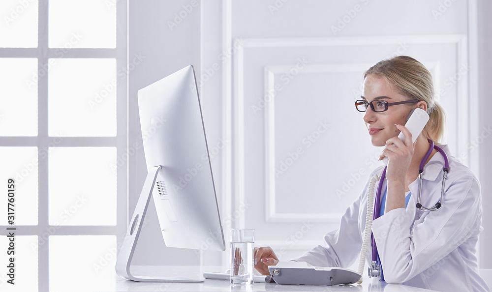 Portrait of a happy smiling young doctor in headset in office Portrait of a happy smiling young doctor in headset in office