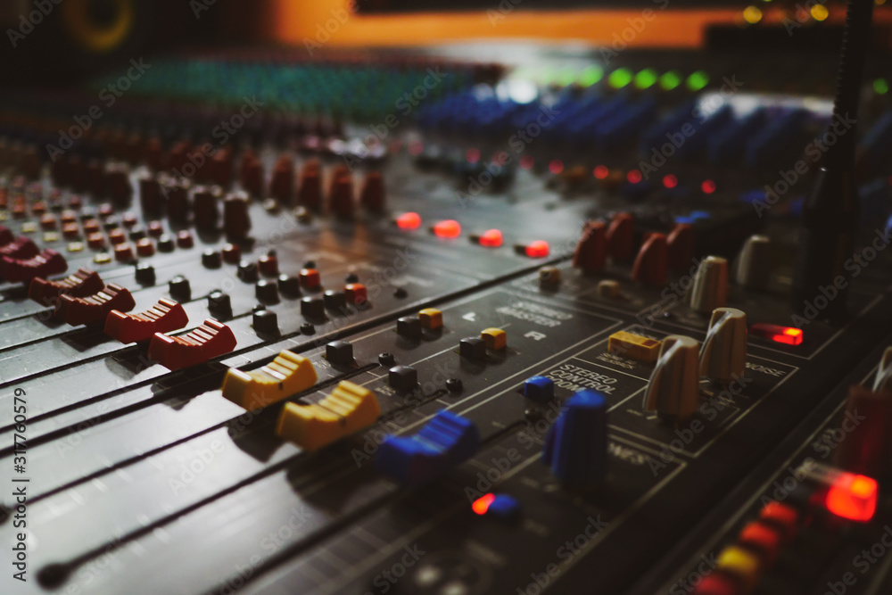 Music producer working in music studio, controlling the sound mixer Music producer working in music studio, controlling the sound mixer