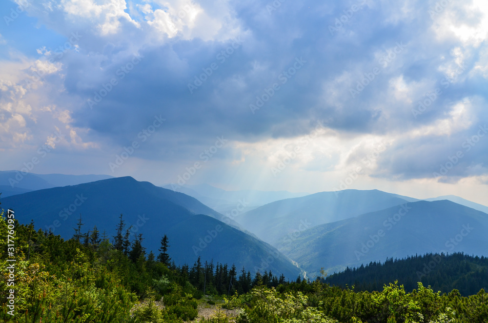 Beautiful landscape of Ukrainian Carpathian mountains, forest and cloudy sky.