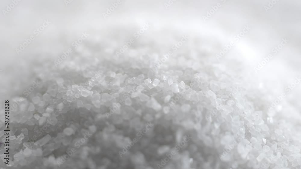 Hourglass. White sand running though. Hourglass extreme close up. Hourglass. White sand running though. Hourglass extreme close up.