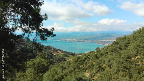 Mountain wiew with turquoise water and green trees. Reflection in the water. Beautiful spring landscape with mountains, forest and lake. Aerial View. Drone shot over a beautiful mountain forest lake