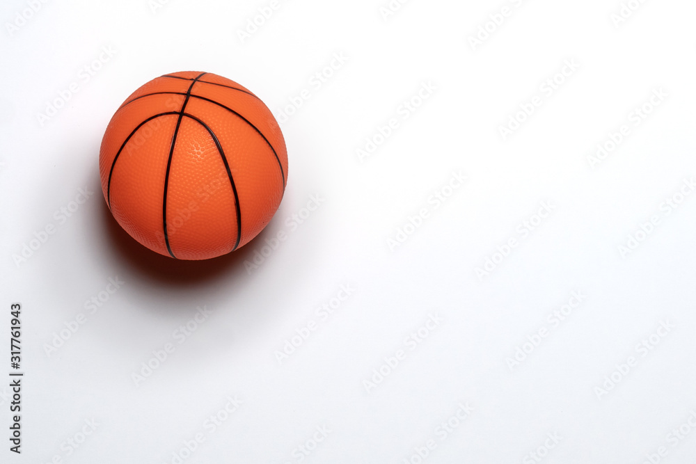 Single small rubber toy basketball isolated on white background