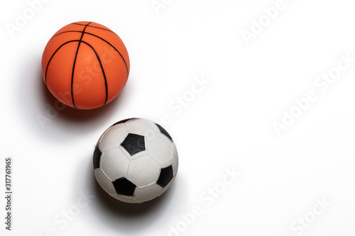 Single small rubber toy basketball and soccer ball isolated on white background