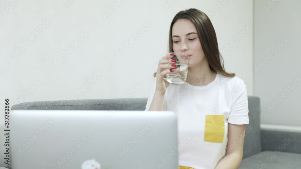 Young girl Business woman taking medicine, holding pills, glass of water at workplace, working hard with laptop while feeling sick, medicine, health care Medical people concept.. Young girl Business woman taking medicine, holding pills, glass of water at workplace, working hard with laptop while feeling sick, medicine, health care Medical people concept..