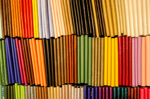 Colorful spines of notebooks on display at a market in Bangkok