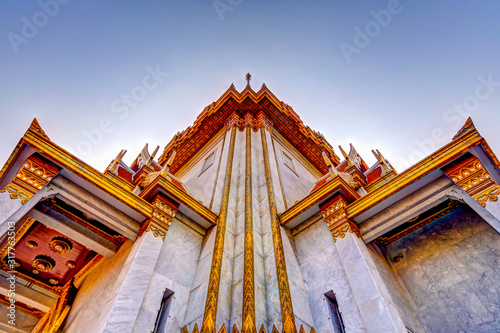 The gold buddha and exterior details of the Wat Traimit temple in Bangkok