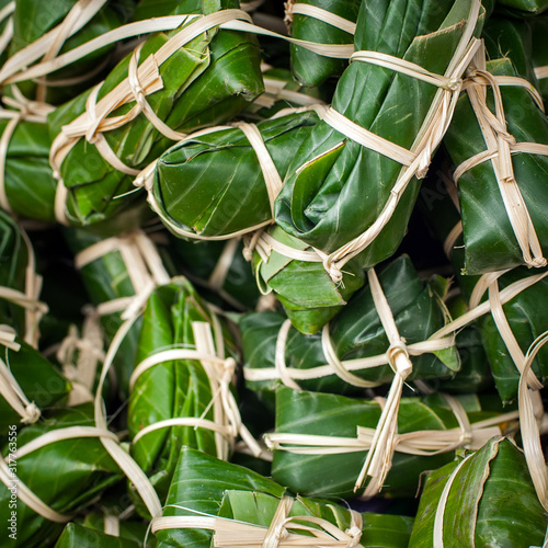 Steamed sticky rice in banana leaf for sale at asian market. Organic food background