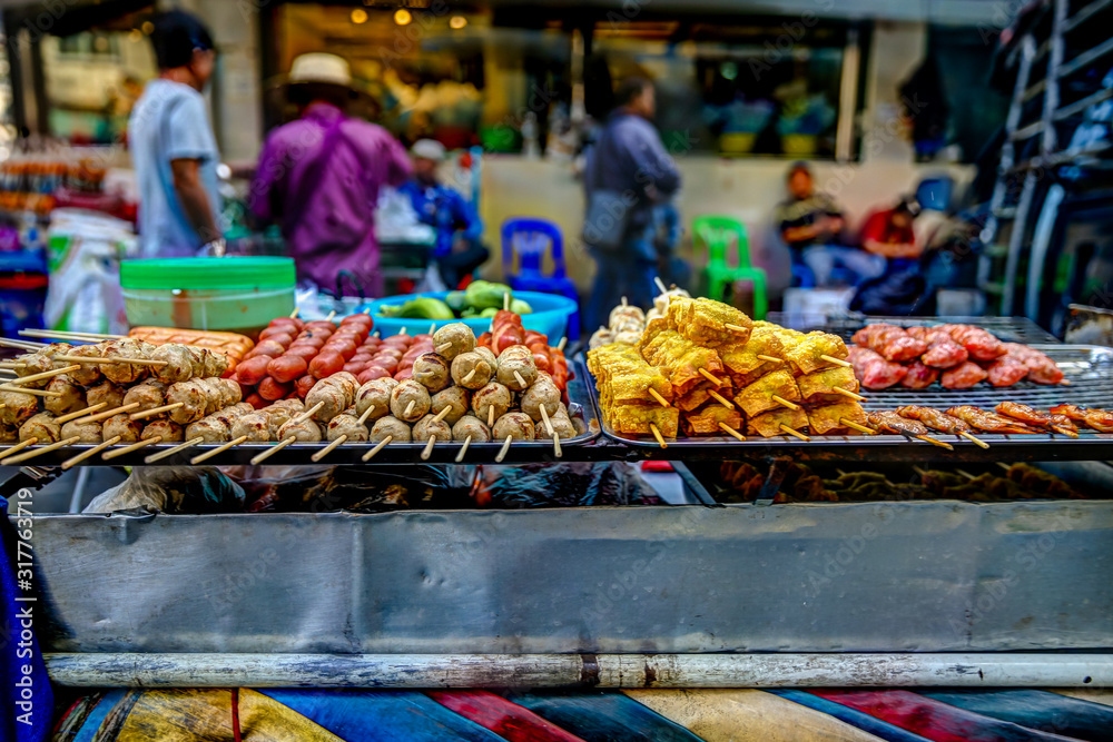Street food for sale on a vendor cart in Bangkok