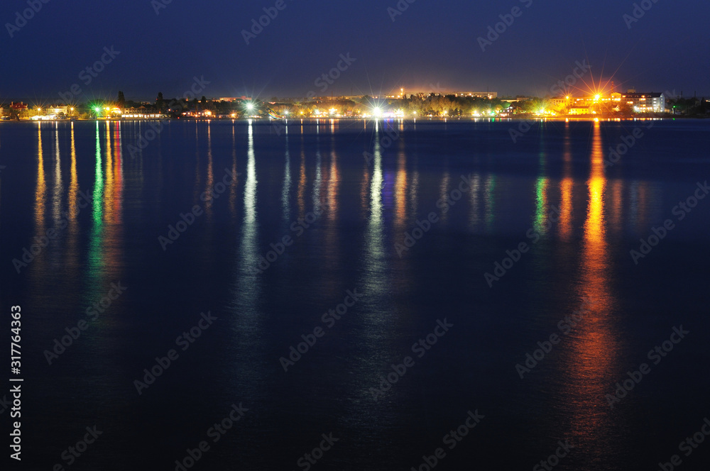 Night coastline, view from the pier of sea port