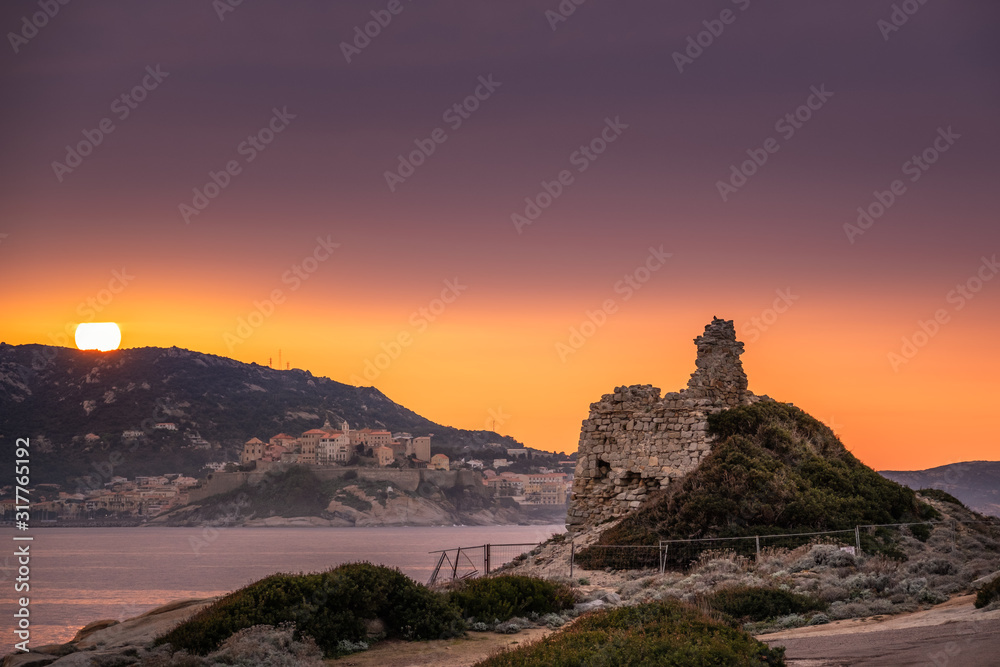 Sun setting behind citadel of Calvi in Corsica
