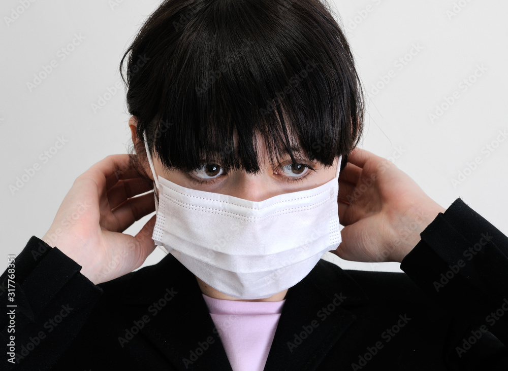close-up portrait of young woman in protective medical mask close-up portrait of young woman in protective medical mask