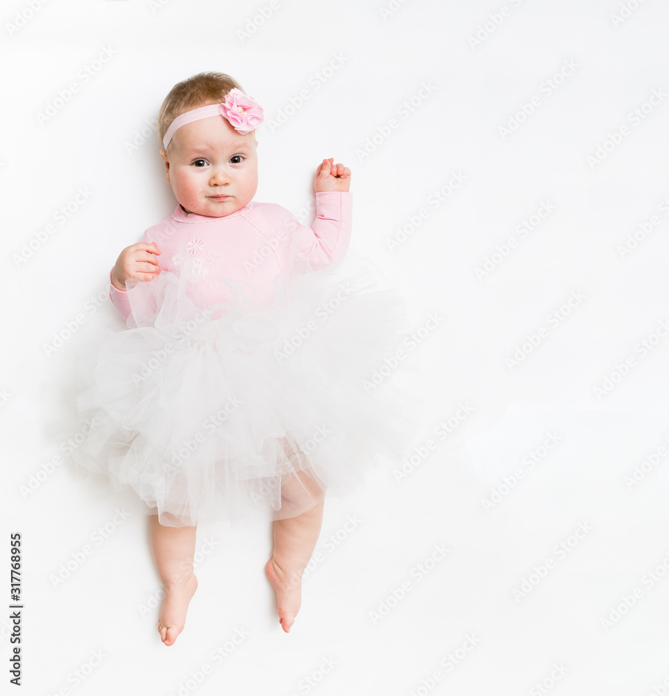Portrait of a sweet infant wearing a pink tutu and headband bow, isolated on white in studio Portrait of a sweet infant wearing a pink tutu and headband bow, isolated on white in studio