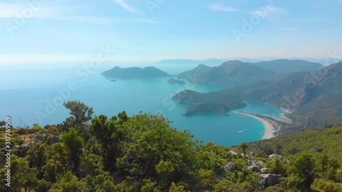 Aerial view of summer city near mountains and sea water. Flying above mountains. Drone shot