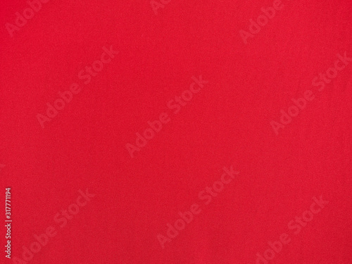 Red fabric made of fine threads, textured surface. top view. Red background.