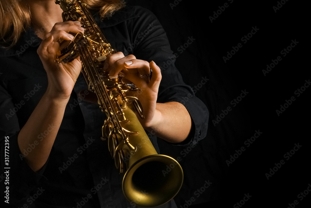Fototapeta premium soprano saxophone in hands on a black background