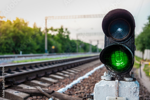 green traffic lights on the railroad