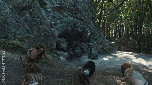 Fotografía Prehistoric Tribe of Neanderthals Attacking Hunting Dangerous Dinosaur T-Rex at Cave