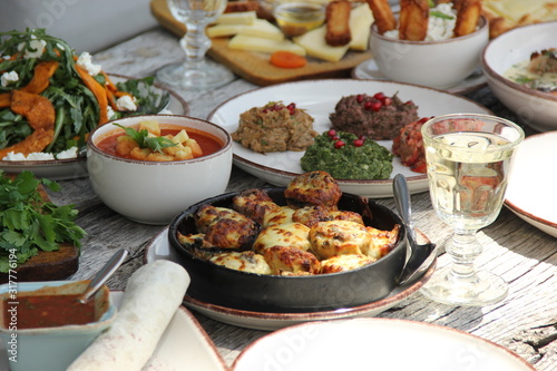 Georgian national cuisine,.food on a wooden table with fresh vegetables and herbs