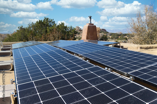 Solar panel installation on a flat New Mexico roof, in horizontal format