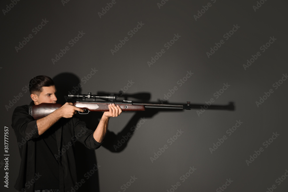Professional killer with sniper rifle on black background Professional killer with sniper rifle on black background