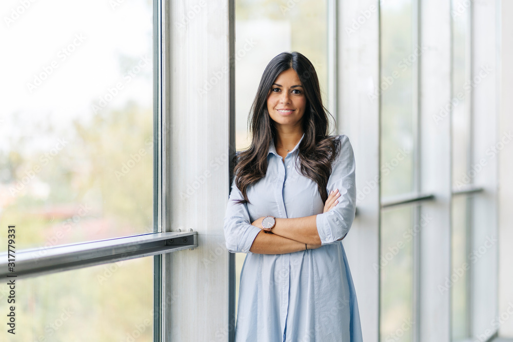 Portrait of a confident businesswoman at the window Portrait of a confident businesswoman at the window