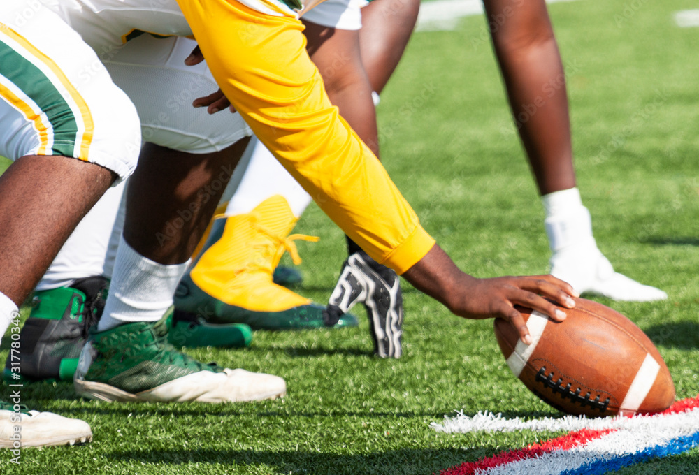 Center holding the ball ready to snap it Center holding the ball ready to snap it