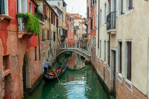 A beautiful photo of the canals of Venice through which gondolas walk and carry tourists © slava2271
