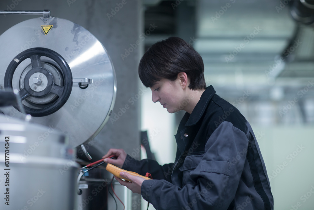 © Cavan Images - engineer woman with a device checking and controlling