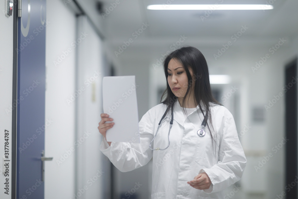 asia woman doctor checking protocol in a hospital asia woman doctor checking protocol in a hospital