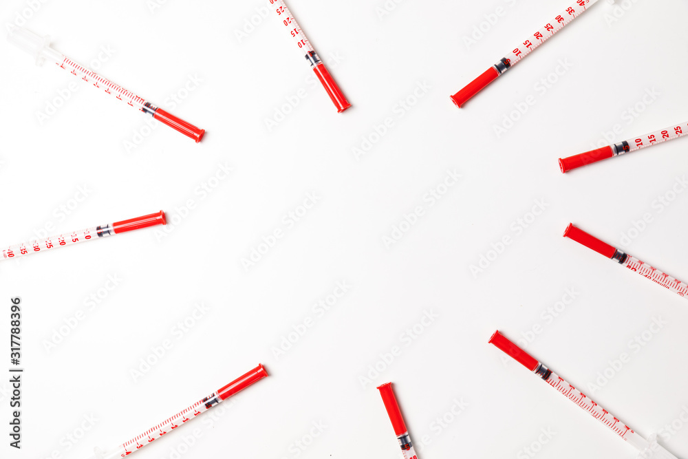 Pile of medical syringes for insulin for diabetes. Syringe on white background Pile of medical syringes for insulin for diabetes. Syringe on white background