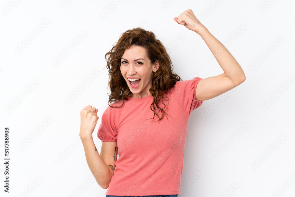 Young pretty woman over isolated background celebrating a victory