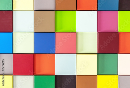 Multi-colored wooden cubes with 3D effect. Background from colored squares.