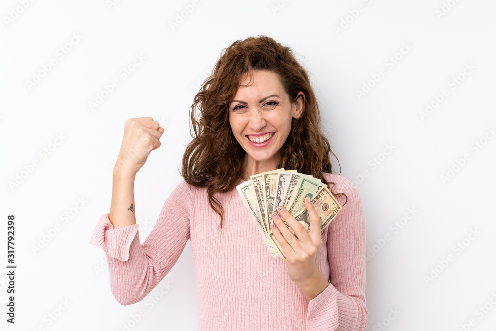 Young pretty woman over isolated background taking a lot of money Young pretty woman over isolated background taking a lot of money
