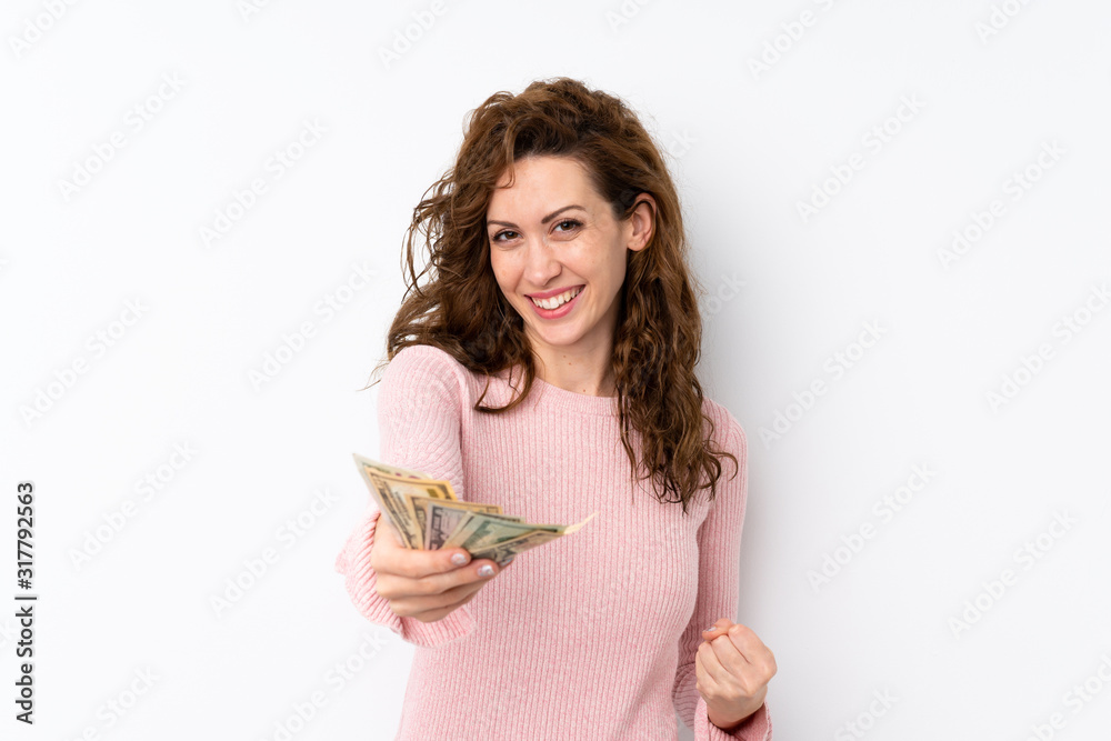 Young pretty woman over isolated background taking a lot of money Young pretty woman over isolated background taking a lot of money