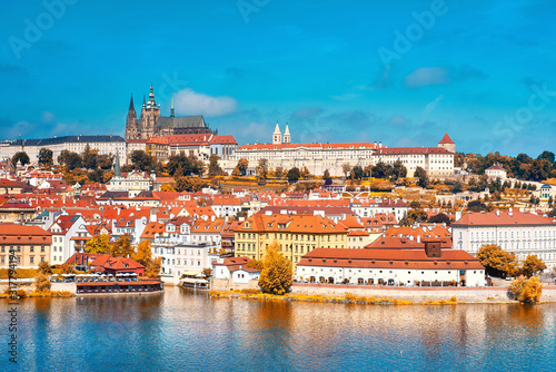 View on St. Vitus Cathedral and Prague Castle from across Vltava river on a bright day in Fall