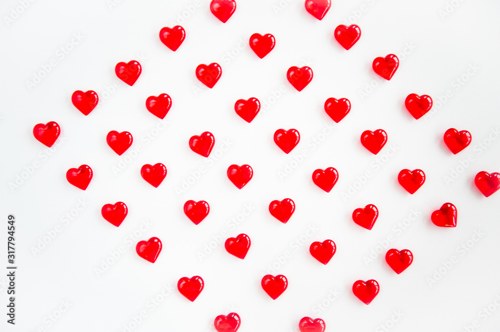 Lots of red hearts on a white background with space for text. Copy space